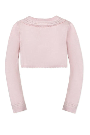 Back view of a pink cropped cardigan with long sleeves, featuring a scalloped hem and delicate pointelle detailing.