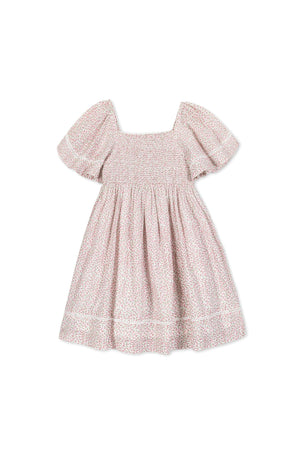 Girls vintage-style dress with pink floral print, featuring smocked bodice and bell sleeves, made from organic cotton.