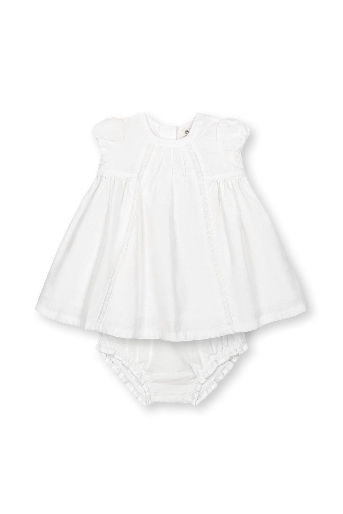 A white linen pintuck dress for babies with puff cap sleeves and a matching diaper cover, perfect for special occasions.