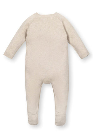 Back view of a beige organic cotton footed romper for babies, featuring long sleeves and textured stitching.
