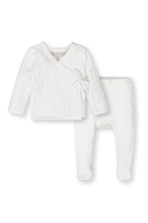White organic cotton baby sweater and footed leggings set by Hope & Henry with pointelle detail and side-tie closure.