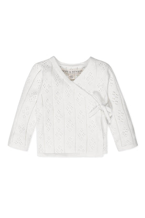 White organic cotton baby sweater with pointelle pattern and side-tie closure, by Hope & Henry.