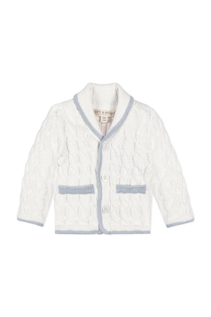 A cozy, white knitted cardigan features a shawl collar and blue accents, perfect for babies. Made from organic cotton, it offers softness and comfort for everyday wear.