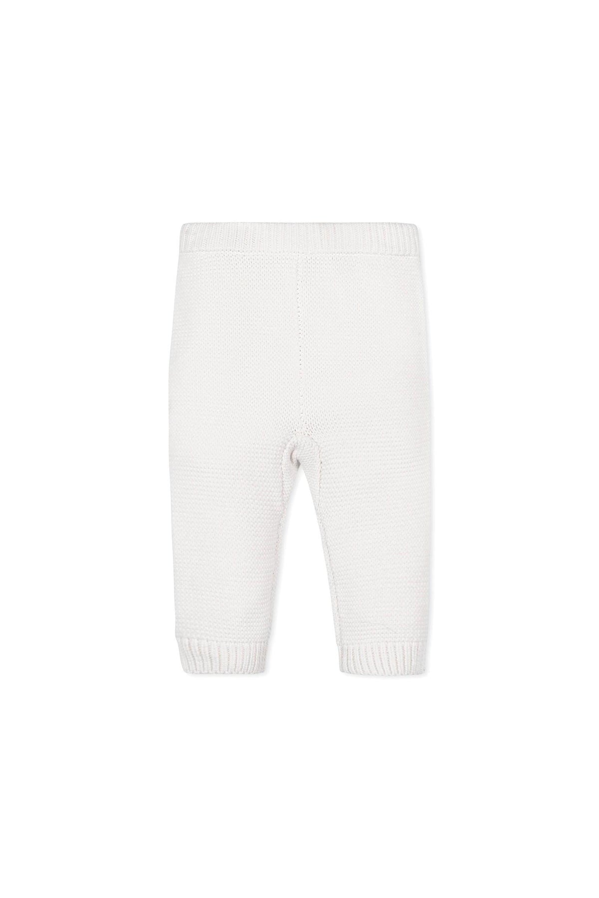 Organic cotton baby leggings in a soft cream color feature a textured knit design and ribbed cuffs.