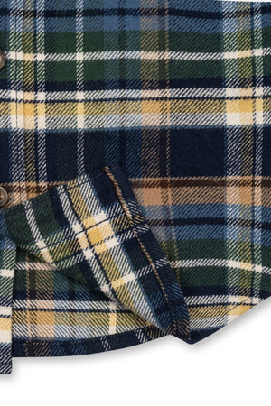Close-up view of a navy plaid organic cotton flannel shirt featuring rich green, yellow, and white check patterns. This soft, sustainable fabric is perfect for boys ages 2T to 18/20.