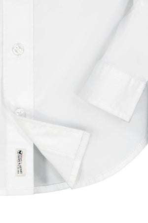 Close-up of a crisp white button-down shirt made from organic cotton poplin, featuring a classic collar and rolled cuffs. Ideal for boys, combining comfort and style for various occasions.