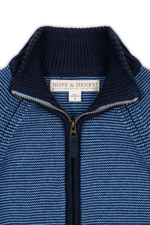 Close-up view of a blue organic cotton sweater by Hope & Henry, featuring a full zip mock neck and a textured knit pattern, ideal for boys sizes 2T to 18/20.