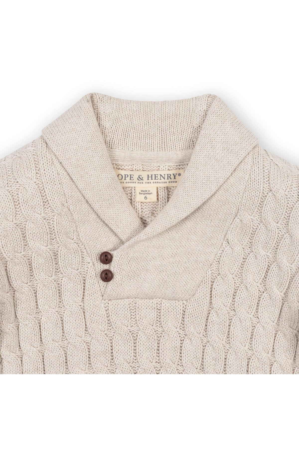 Light oatmeal shawl collar cable sweater made from soft organic cotton, featuring a button closure and intricate cable knit design.