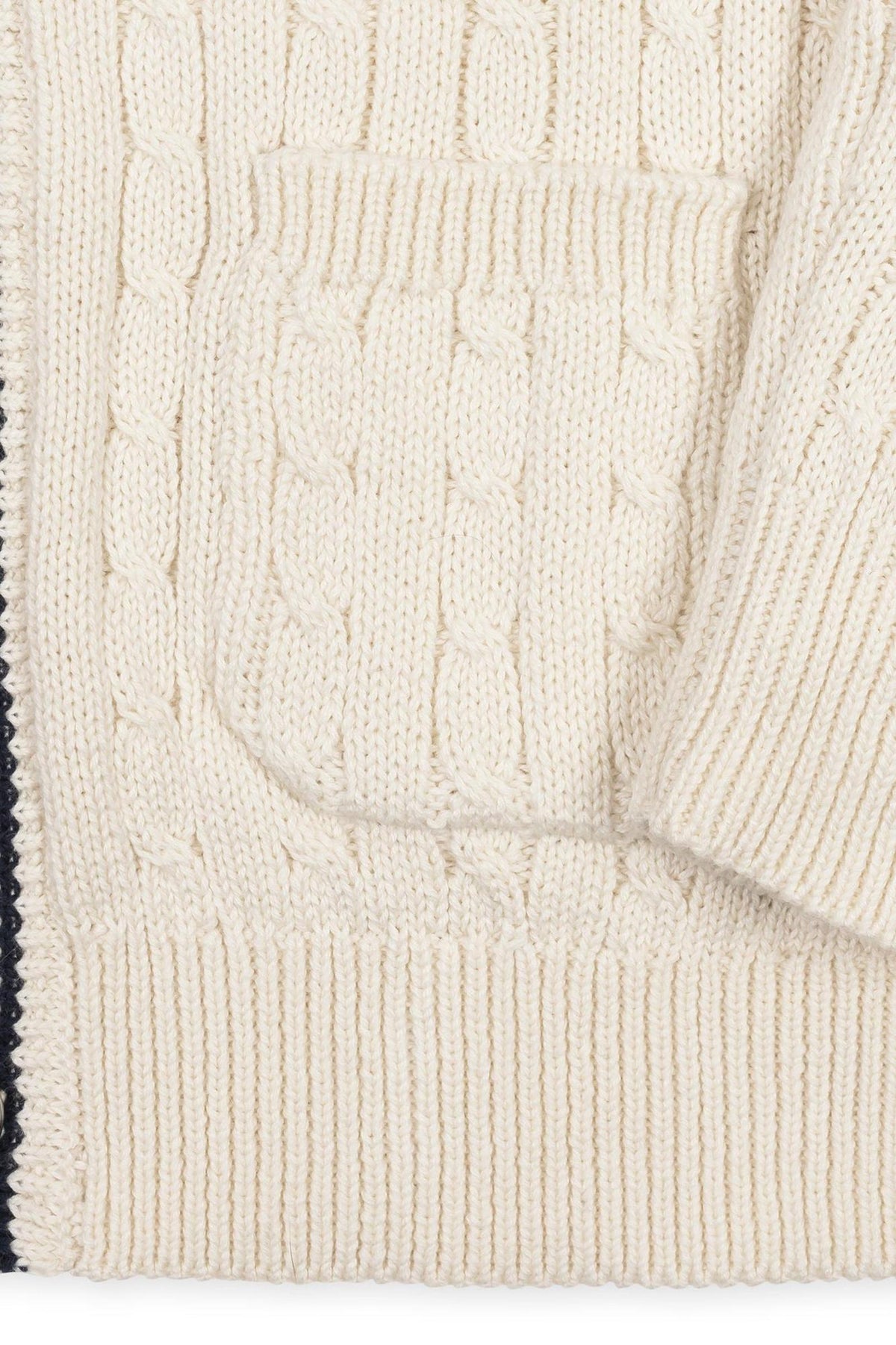 Close-up of an ivory organic cotton cable cardigan featuring a textured knit pattern and a patch pocket. Ideal for boys sizes 2T to 18/20, it offers cozy, sustainable comfort.