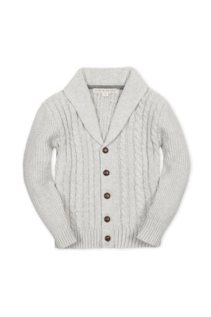 Light gray organic cotton shawl collar cardigan featuring a textured cable knit design and wooden buttons, suitable for boys sizes 2T to 18/20. Perfect for stylish, sustainable everyday wear.