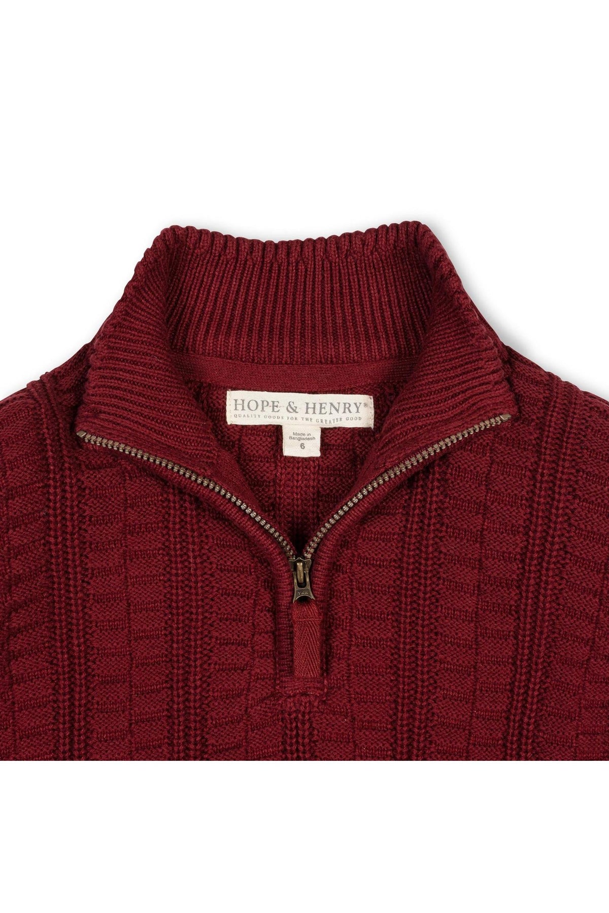 Close-up of a rich oxblood half-zip cable sweater made from 100% organic cotton, featuring a textured knit design.