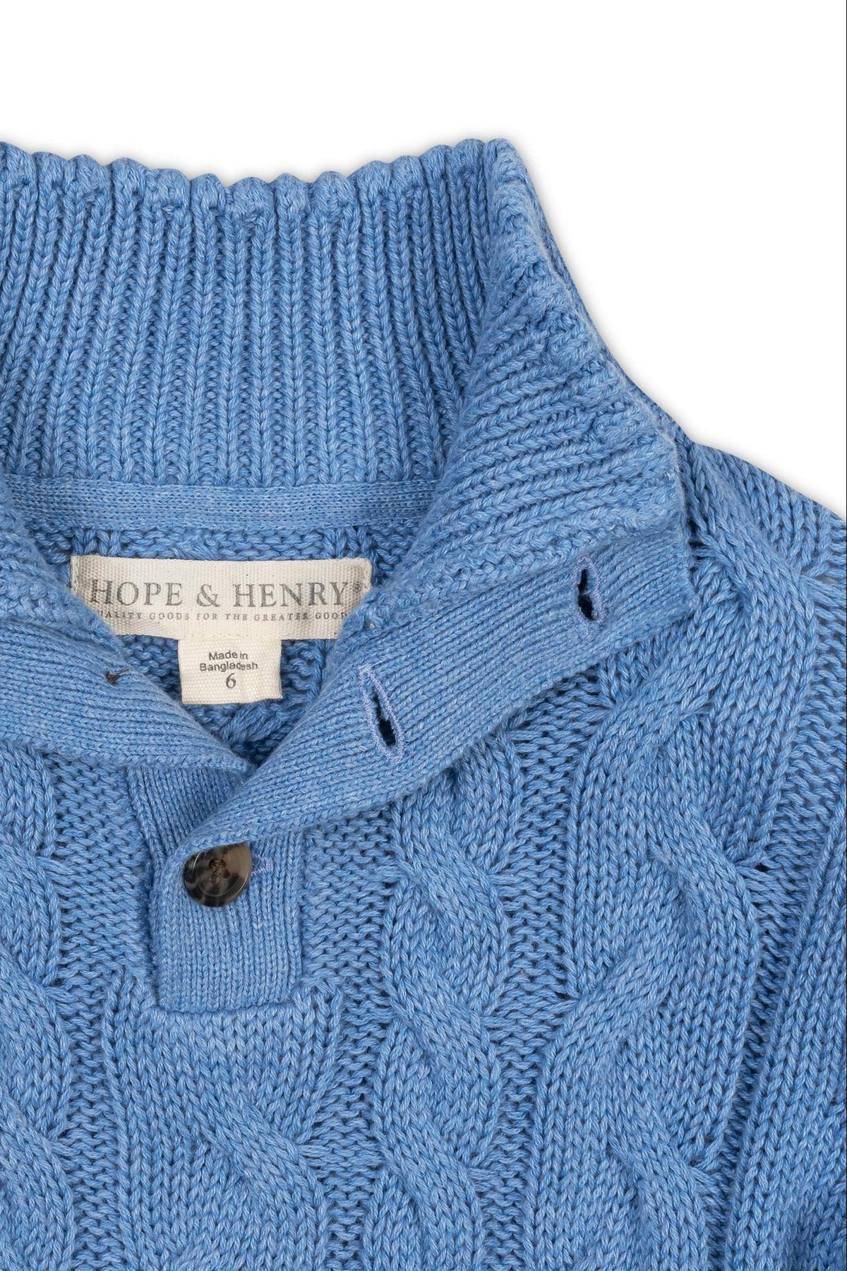 Close-up of a medium blue organic cotton mock neck cable sweater by Hope & Henry, showcasing a textured cable knit design and front button placket. Ideal for cool weather wear.