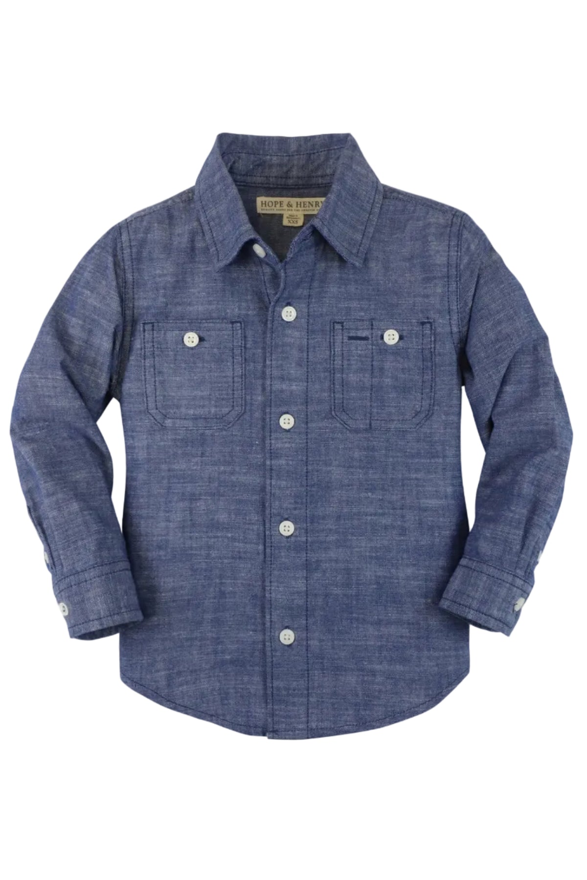 A classic boys chambray button-down shirt in a rich blue hue, featuring two front pockets and white buttons. Made from 100% organic cotton, its perfect for everyday wear.
