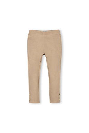 Camel-colored ponte pants made from organic cotton feature a slim fit and button cuffs, ideal for toddlers and girls. These stylish pants offer comfort and versatility for everyday wear.