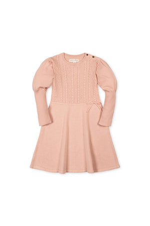 Soft blush sweater dress featuring a cable knit bodice and ribbed sleeves. Made from 100% organic cotton, this stylish dress is perfect for toddlers and girls at special occasions.