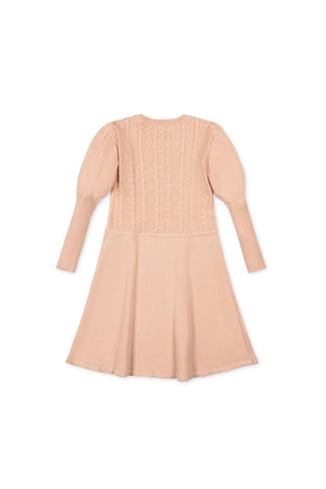 Back view of a blush organic cotton cable knit sweater dress, featuring puffed sleeves and a textured bodice. Ideal for toddlers and girls, it combines style and comfort sustainably.