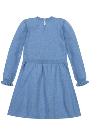 Back view of a medium blue organic cotton sweater dress featuring long sleeves, ruffle cuffs, and a keyhole closure at the back.