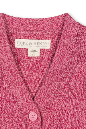 A close-up of a vibrant pink V-neck cardigan made from organic cotton, featuring a textured knit and a single button closure. The label reads Hope & Henry, indicating quality craftsmanship.