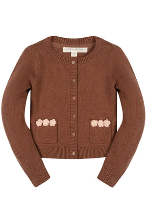 A cinnamon brown cardigan from Hope & Henry features a classic design with rosette pockets. Made from 100% organic cotton, its perfect for toddlers and girls seeking comfort and style.