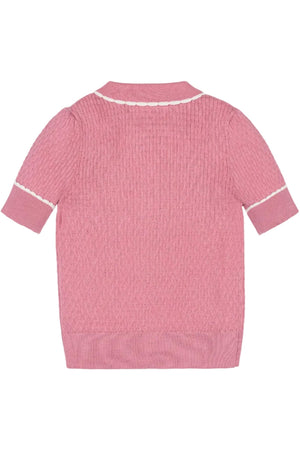 Back view of a pink organic cotton sweater polo featuring a textured knit, short puffed sleeves, and a knit peter pan collar with white tipping, designed for sustainable childrens fashion.