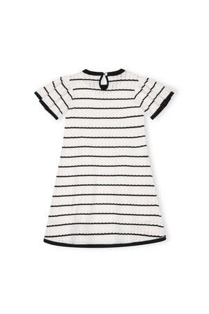 Back view of a toddler and girls A-line sweater dress in black and white organic cotton, featuring short sleeves, a pointelle design, and a button closure at the neckline.