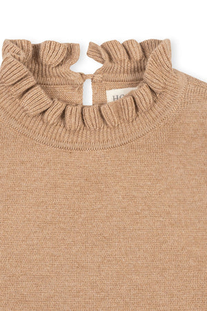 Close-up of a camel-colored organic cotton sweater dress featuring a ruffled mock neck and a keyhole back. The soft fabric is perfect for toddlers and kids, combining comfort and style.