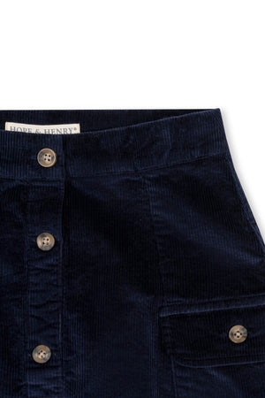 Navy corduroy button-front skirt featuring two front pockets and a classic design, made from GOTS certified organic cotton, ideal for toddlers and girls. Perfect for stylish, eco-friendly outfits.