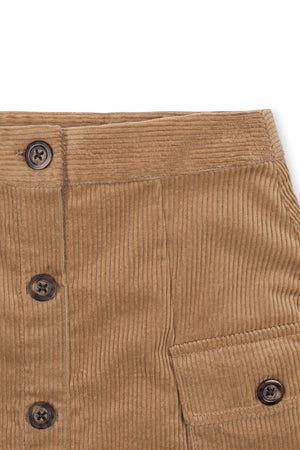 Close-up of a brown organic cotton corduroy skirt featuring a button front and side pocket. The soft fabric and sustainable material make it ideal for toddlers and girls.