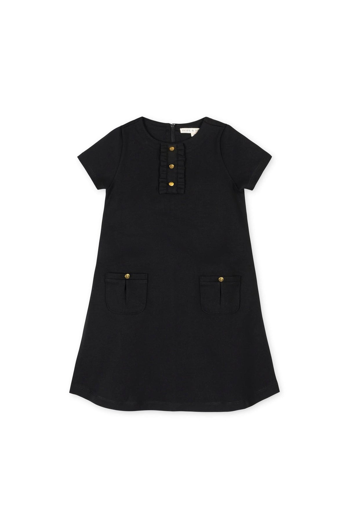 A black A-line dress featuring short sleeves, a ruffle placket, and button details, with two front pockets. Made from organic cotton, its perfect for toddlers and girls.