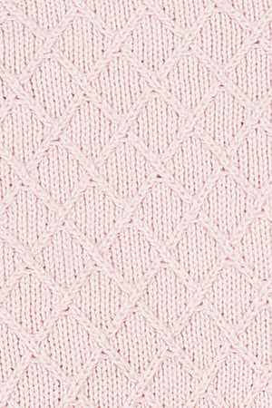 Close-up of a pale pink organic cotton blanket featuring a textured diamond stitch pattern. The soft fabric showcases its sustainable qualities, perfect for cozying up with your little one.
