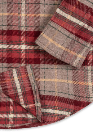 Close-up of a rosy taupe plaid flannel shirt featuring buttons and a rounded hem. Made from soft organic cotton, this sustainable shirt is designed for ages 2T-18.