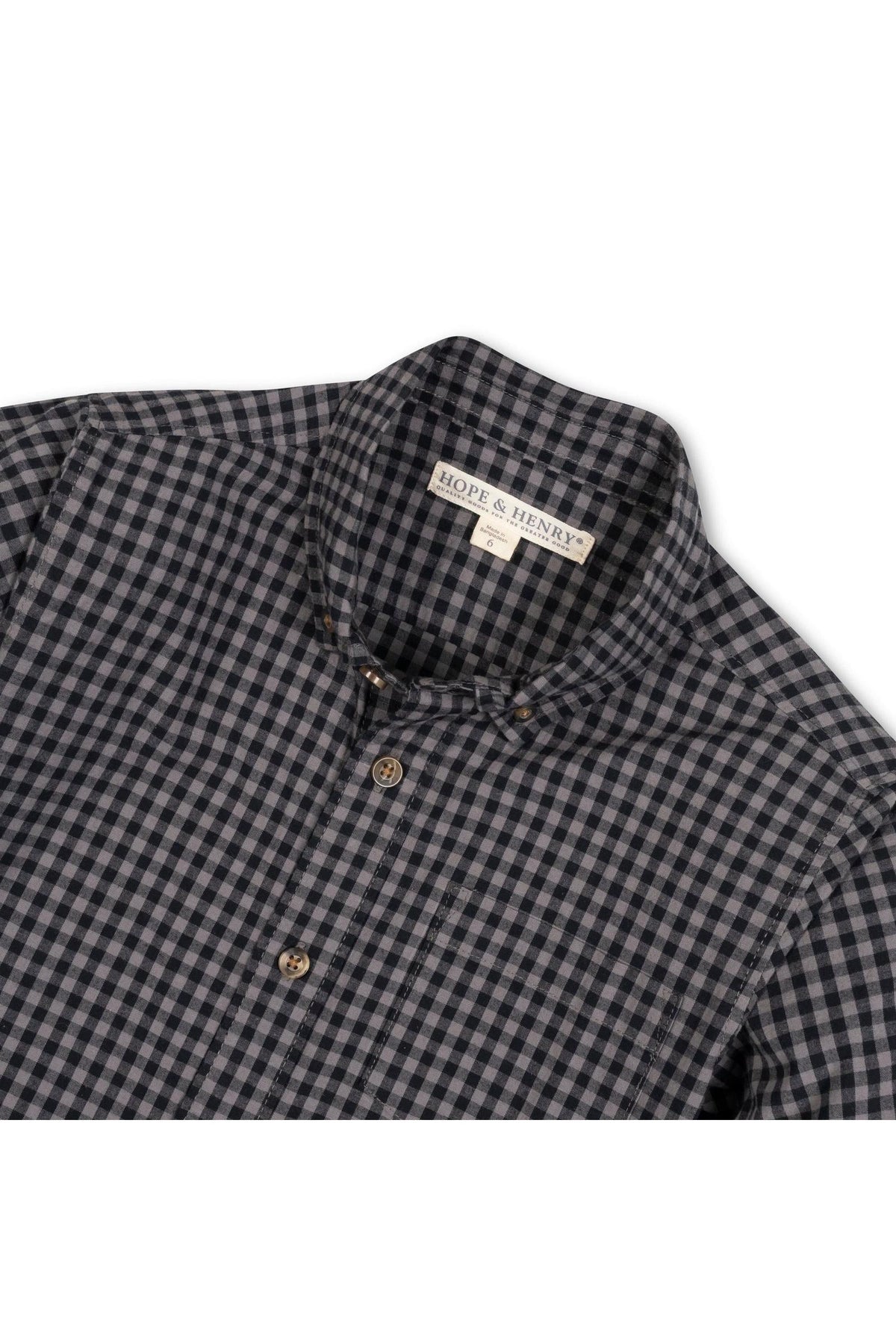 Black gingham button-down shirt made from soft organic cotton, featuring a classic collar and two front buttons. Ideal for ages 2T-18, showcasing sustainable and comfortable style.