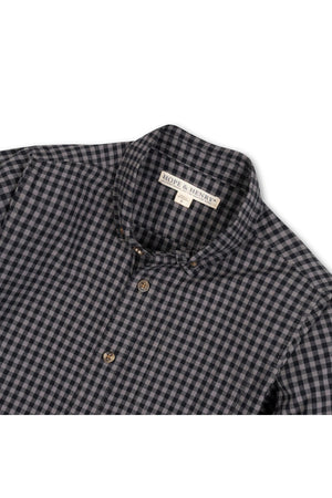 Black gingham button-down shirt made from soft organic cotton, featuring a classic collar and two front buttons. Ideal for ages 2T-18, showcasing sustainable and comfortable style.