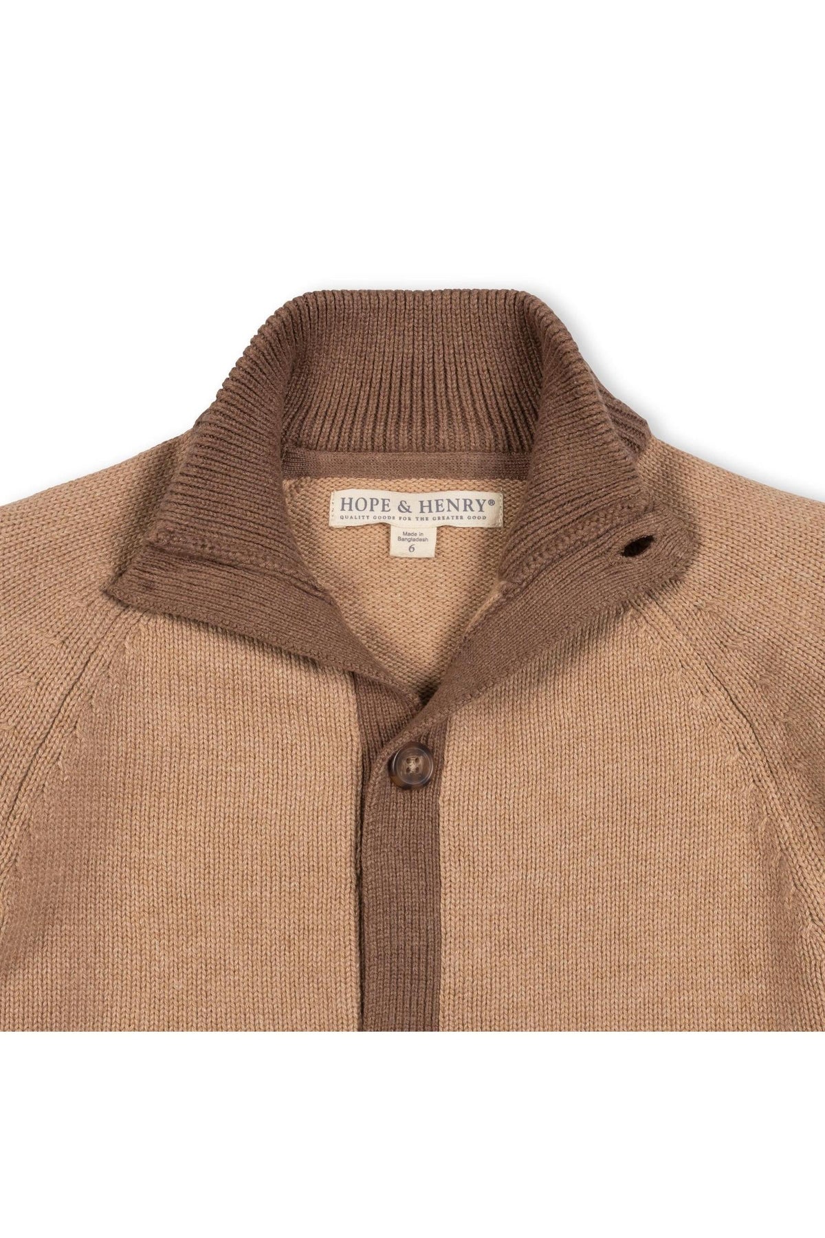 A close-up view of a camel and cinnamon mock neck cardigan made from soft organic cotton. The sweater features a button front closure and a cozy ribbed collar.