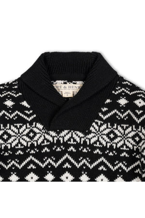A close-up view of a black and white organic cotton shawl collar sweater featuring a snowflake pattern. The sweater is labeled with the brand name Hope & Henry.