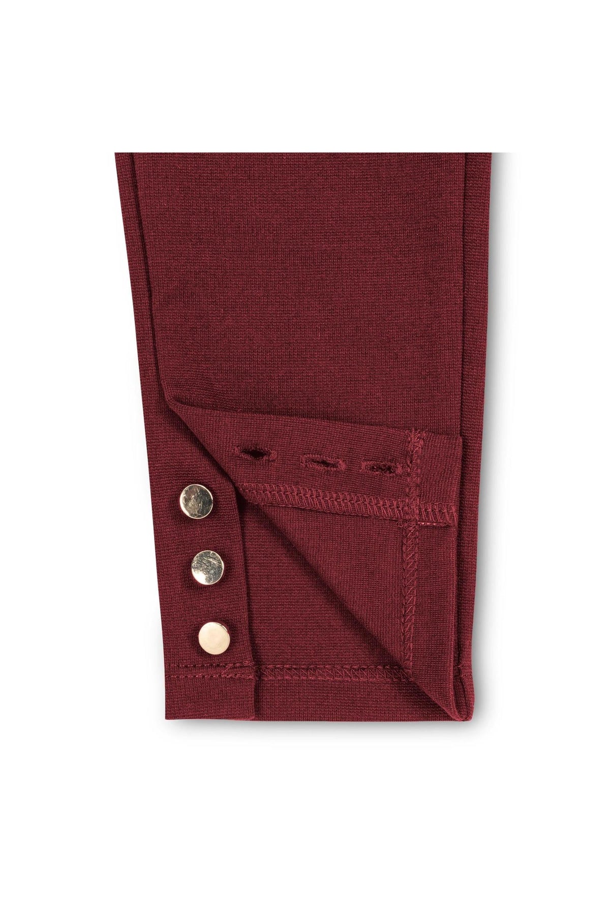 Close-up image of the hem of a burgundy ponte pant featuring three gold shank buttons at the ankle. The fabric is thick and textured, ideal for toddlers and girls.