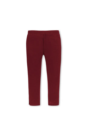 Oxblood ponte pants for toddlers and girls feature a slim fit and gold shank buttons at the ankle cuffs. The cozy knit material offers a comfortable, pull-on style.