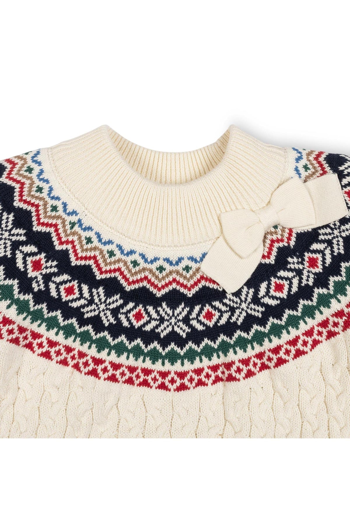 Ivory organic cotton mock neck sweater featuring a colorful Fair Isle design and a bow detail at the collar. This cozy piece is perfect for toddlers and kids.
