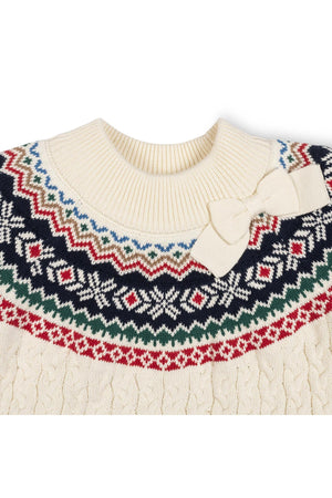 Ivory organic cotton mock neck sweater featuring a colorful Fair Isle design and a bow detail at the collar. This cozy piece is perfect for toddlers and kids.