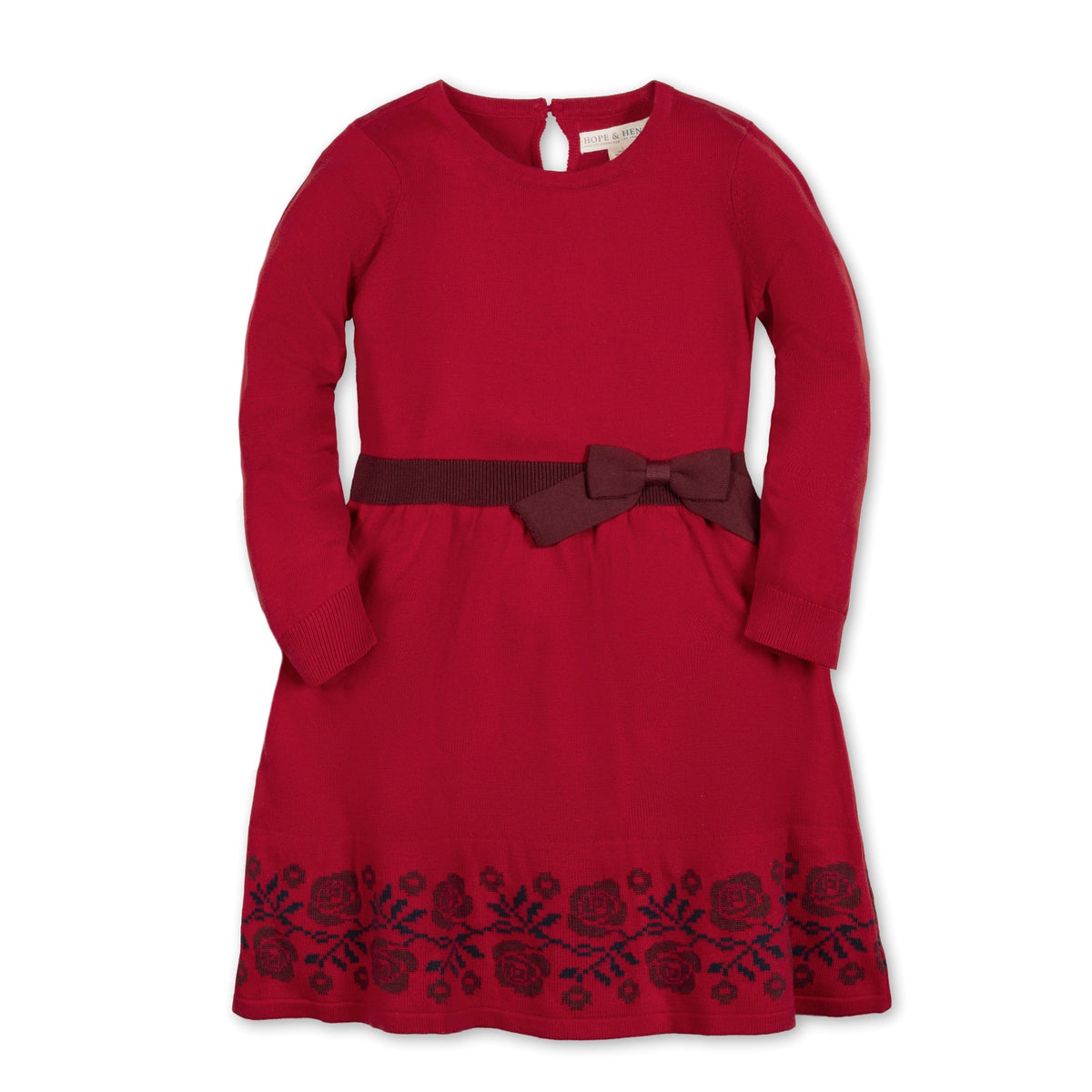 A vibrant red organic cotton skater sweater dress features long sleeves, a decorative bow at the waist, and floral intarsia detailing along the hem, perfect for toddlers and girls.