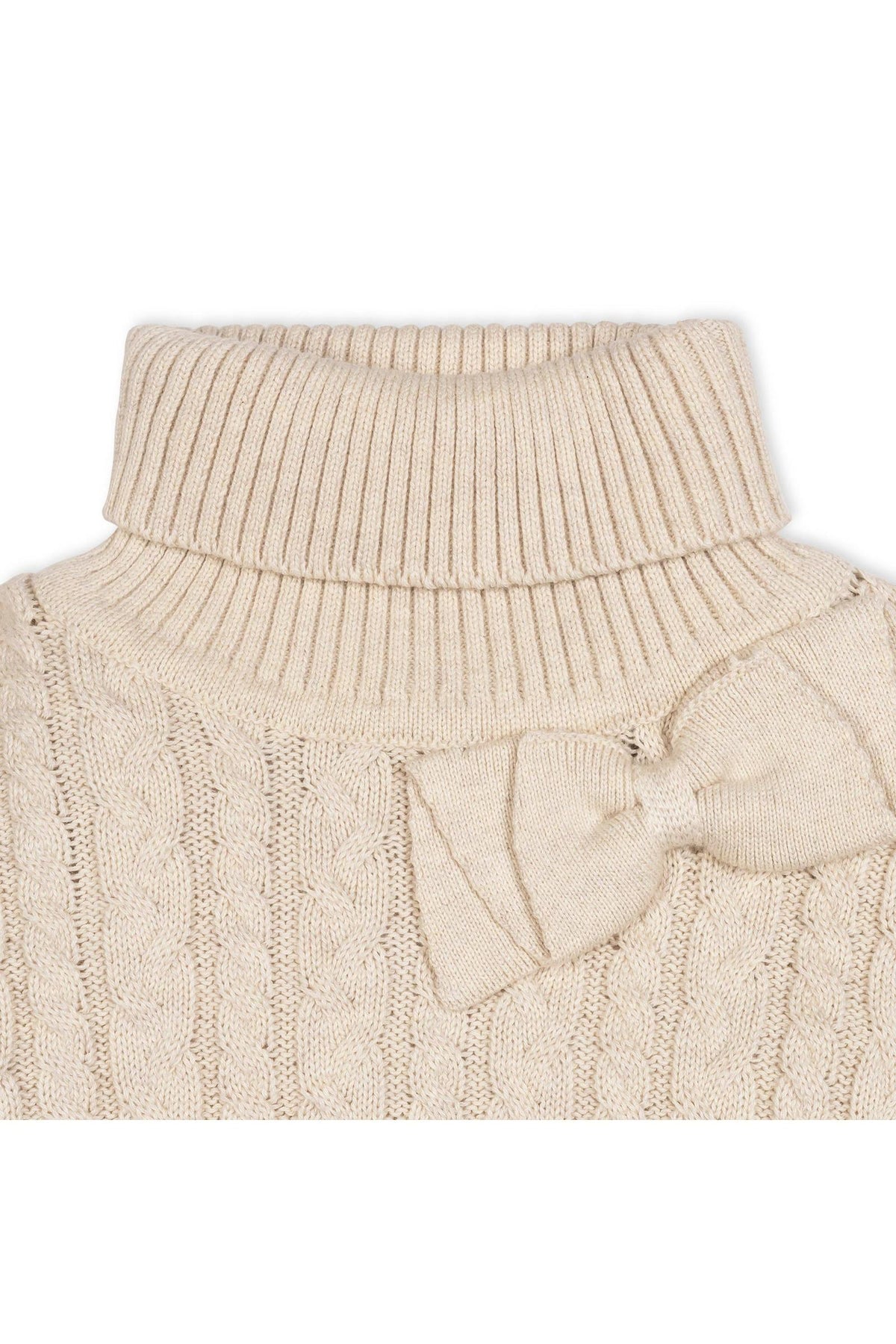 Close-up of a light oatmeal organic cotton turtleneck sweater cape featuring a cozy rib knit design and a bow detail at the neck, ideal for toddlers and girls.