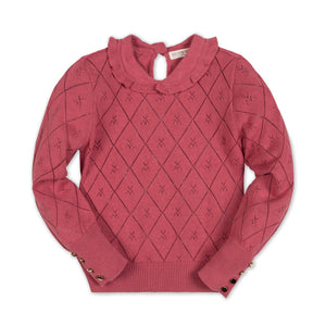 A rosewood-colored organic cotton sweater featuring a delicate Peter Pan collar and diamond knit pattern. It includes gold button cuffs and a keyhole closure at the back for easy dressing.