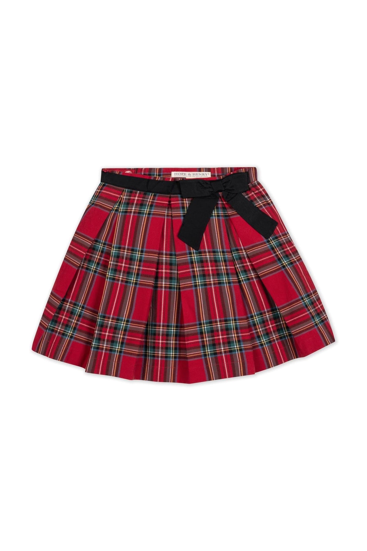 Red holiday tartan pleated skirt featuring a black waist sash and bow. Made from soft organic cotton, this stylish piece is perfect for toddlers and girls festive occasions.