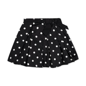 Black pleated party skirt featuring white polka dots and a stylish waist sash with bow. Made from soft organic cotton, this skirt is perfect for toddlers and girls.