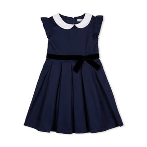 A navy blue toddler dress features a woven white Peter Pan collar, flutter sleeves, and a black waist sash with a bow.