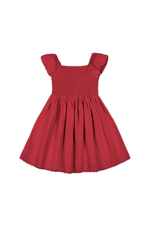 Red organic cotton sateen flower girl dress featuring a smocked bodice and gently puffed sleeves. Perfect for special occasions, this dress combines elegance with comfort for toddlers and girls.