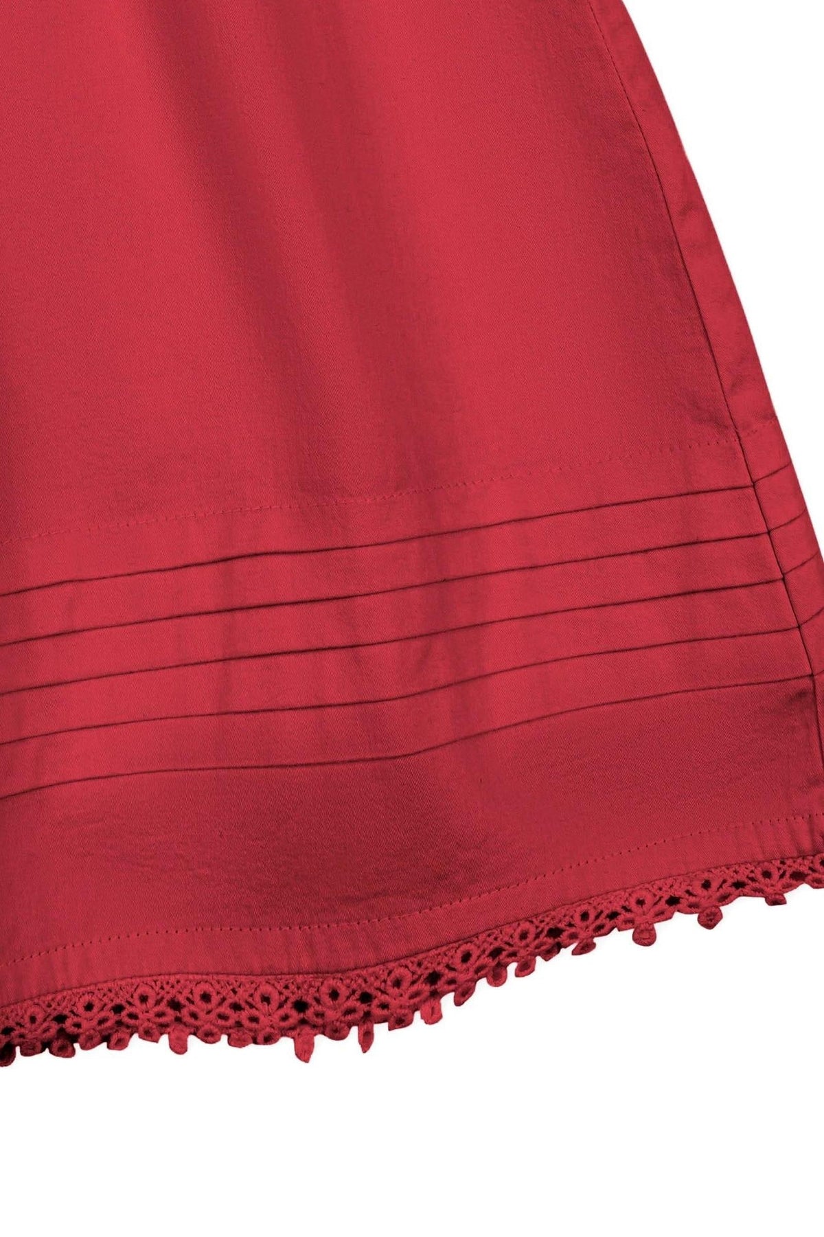 Close-up view of a red organic cotton sateen dress featuring a pintucked hem with delicate crochet trim.
