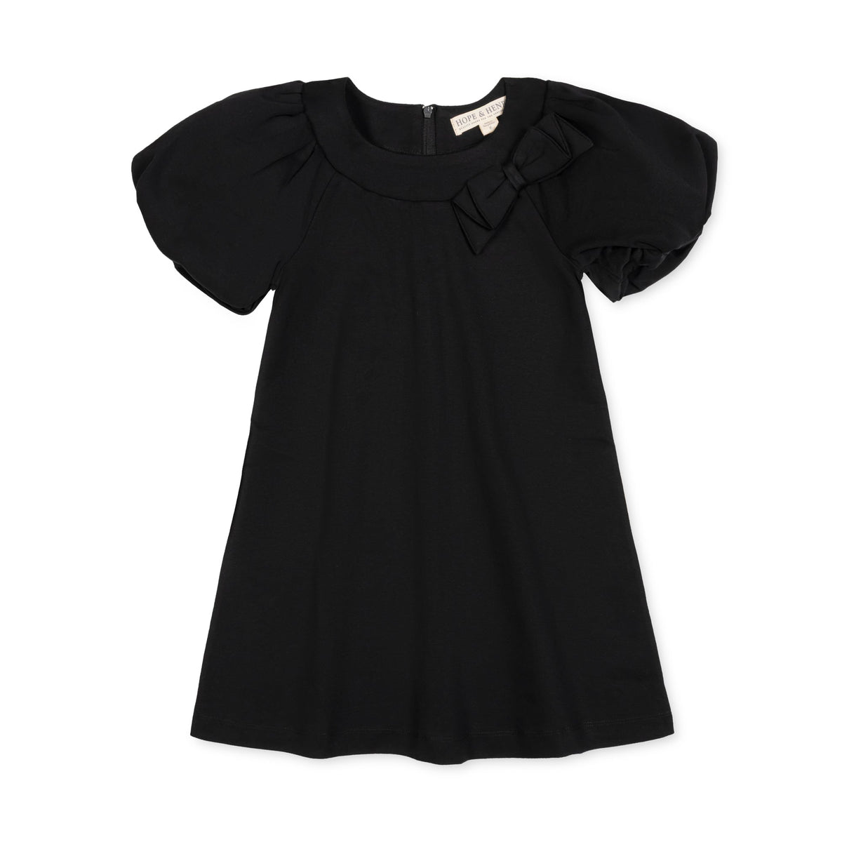 Black organic cotton dress featuring bubble sleeves and a bow at the neckline. This toddler dress offers a comfortable swing silhouette, perfect for both playdates and special occasions.