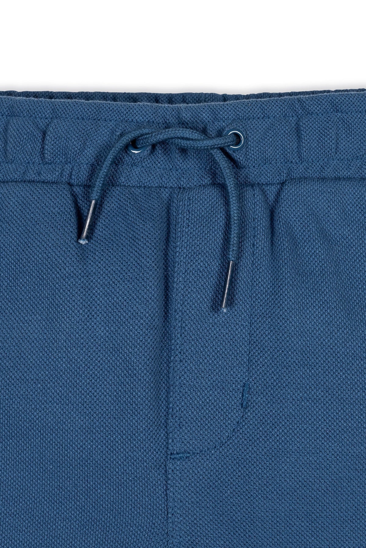 Close-up of stone blue organic cotton pique pull-on shorts featuring an elastic waistband and adjustable drawstring. The lightweight fabric is perfect for comfortable, everyday wear for children.