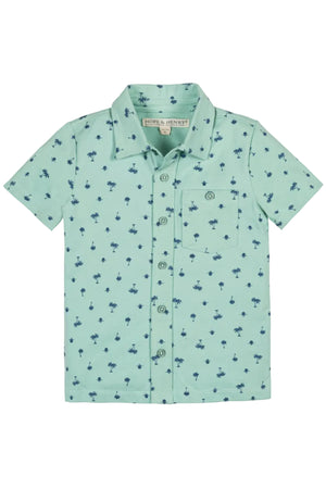 Light blue organic cotton button-down shirt featuring a playful palm tree print, designed for kids. This soft, breathable fabric is perfect for summer adventures and outdoor activities.